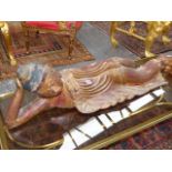 A THAI OR BURMESE GOLD LACQUERED WOOD RECLINING BUDDHA, HIS ROBE EDGES JEWELLED WITH COLOURED GLASS.