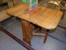 A SMALL ARTS AND CRAFTS OAK DROP LEAF OCCASIONAL TABLE WITH MORTICE PEGGED STRETCHERS. 92 x 61 x H.