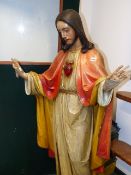 A PAINTED CARVED WOOD FIGURE OF JESUS, HIS HANDS RAISED IN BLESSING