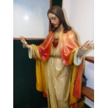 A PAINTED CARVED WOOD FIGURE OF JESUS, HIS HANDS RAISED IN BLESSING