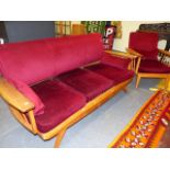 A MID CENTURY THREE PIECE SUITE COMPRISING A THREE SEATER SOFA AND TWO ARMCHAIRS WITH SPINDLE
