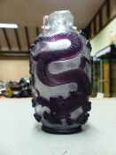 A CHINESE PURPLE OVERLAY CLEAR GLASS SNUFF BOTTLE DEPICTING DRAGONS. H.11.5cms.