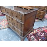 A SMALL EARLY OAK CHEST OF THREE DRAWERS OPENING ON CENTRAL RUNNERS TO EACH SIDE ABOVE BRACKET FEET.