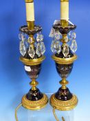 A PAIR OF ORMOLU MOUNTED RUBY OVERLAY GLASS LUSTRE CANDLESTICK TABLE LAMPS. H.37cms.