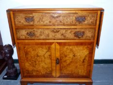 OBADIAH OTTERBROOK, A BURR WALNUT FLAP TOP SIDE BUTLER'S SIDEBOARD, THE TOP, TWO DRAWERS AND
