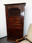 A 19th.C. FRENCH OAK CABINET, THE UPPER DOOR OPEN TO SHELVING THROUGH BALUSTER TURNED BARS, THE