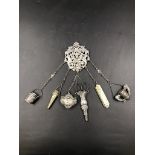 A VICTORIAN SILVER HALLMARKED CHATELAINE, DATED 1890, WITH SIX VARIOUS APPENDAGES, SOME SILVER AND