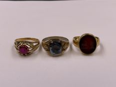 AN 18ct GOLD INTAGLIO SEAL RING, A 9ct GOLD HEMATITE CARVED TROJAN RING AND A RED STONE SET GYPSY