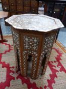 AN ISLAMIC OCTAGONAL TABLE GEOMETRICALLY INLAID IN BONE AND MOTHER OF PEARL WITHIN WHITE METAL LINES