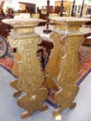 A PAIR OF EARLY CARVED WOOD STANDS GOLD WASHED OVER SILVERING IN THE BAROQUE TASTE, THE NEAR