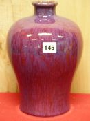 A CHINESE FLAMBE MEIPING, THE OVERALL PURPLE GLAZE STREAKED WITH MAUVE. H 27.5cms. TOGETHER WITH A