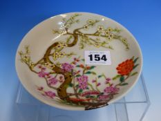 A CHINESE FAMILLE ROSE SAUCER, THE PINK AND YELLOW CHERRY BLOSSOMS FLOWERING FROM TREES EXTENDING