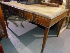 A LATE 19th.C. PALE MAHOGANY WRITING TABLE, THE BROWN LEATHER INSET TOP OVER THREE DRAWERS AND
