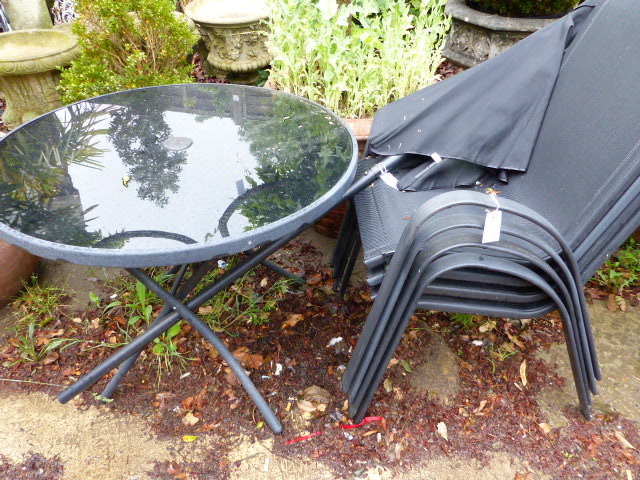 A MODERN PATIO TABLE, PARASOL AND FOUR CHAIRS.