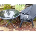 A MODERN PATIO TABLE, PARASOL AND FOUR CHAIRS.