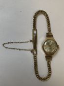 A 9ct GOLD LADIES SEKONDA USSR WATCH ON A 9ct GOLD LADDER CLASP BRACELET STRAP COMPLETE WITH