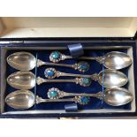 A SET OF SIX TEA SPOONS STAMPED STG SILVER, EACH BEZEL SET WITH A OVAL OPAL WITH FLASHES OF BLUE/