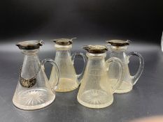 A SET OF FOUR CIRCA 1930'S SILVER MOUNTED AND GLASS WHISKY TOTS ONE WITH A SILVER HALLMARKED WHISKEY