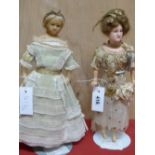 TWO WAX HEADED DOLLS, THE GIBSON GIRL IN EMBROIDERED WHITE MUSLIN DRESS. H 37cms. THE OTHER IN