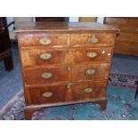 AN 18th.C.WALNUT CHEST OF TWO SHORT AND THREE LONG GRADUATED, CROSS BANDED DRAWERS ON LONG BRACKET