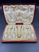 A CASED SET OF SIX SILVER GILT AND WHITE ENAMELLED NORWEGIAN TEASPOONS AND A PAIR OF SUGAR NIPS,