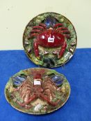 S M J PORTUGAL. TWO MAJOLICA PLATES MODELLED IN HIGH RELIEF WITH A CRAB ON ONE AND A LOBSTER ON