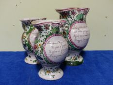 THREE TIN GLAZED CONTINENTAL JUGS, THE BALUSTER BODIES PAINTED WITH FLOWERS IN THE FRENCH STYLE