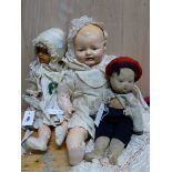 AN EDWARD HORSMAN COMPOSITION DOLL IN SILK CHRISTENING ROBES. H 55cms A K&K PLASTIC DOLL IN A