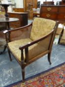A LATE GEORGIAN HARDWOOD BERGERE LIBRARY ARMCHAIR ON REEDED FORELEGS, POSSIBLY COLONIAL.