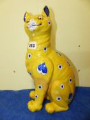 A GALLE STYLE FAIENCE SEATED CAT, POSSIBLY BY MOSANIC, IT'S YELLOW COAT DECORATED IN BLUE WITH