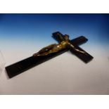 A CRUCIFIX, THE GILT METAL FIGURE OF CHRIST NAILED TO AN EBONISED CROSS. H 46cms.