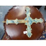 A PAINTED PINE CRUCIFIX WITH CHRIST ON ONE OF THE BLUE MARBLED SIDES AND THE VIRGIN IN PRAYER ON THE