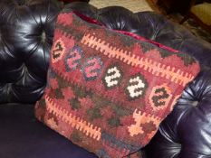 TWO CUSHIONS WITH REMOVABLE RED VELVET AND KELIM COVERS.