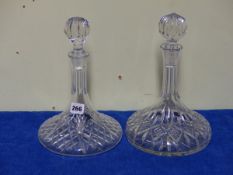 TWO SIMILAR CUT GLASS SHIP'S DECANTERS AND STAR CUT BALL STOPPERS.