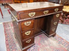 A GEO.III MAHOGANY KNEEHOLE DESK, A SINGLE DRAWER OVER A RECESSED CUPBOARD FLANKED BY BANKS OF THREE
