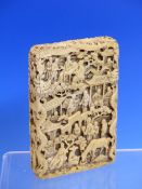 A CHINESE IVORY CARD CASE CARVED IN RELIEF WITH VILLAGERS IN VARIOUS PURSUITS, THE EDGES WITH