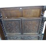 AN OAK SINGLE BED FRAME, THE BARLEY TWIST SIDED HEAD, FOOT AND SIDES CARVED IN RELIEF WITH FOLIAGE.