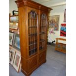 AN EARLY 20th.C.OAK BOOKCASE WITH LEAD GLAZED PANEL DOORS. 105 x 36 x H.191cms.