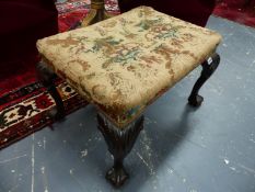 A MAHOGANY STOOL, THE UPHOLSTERED SEAT ON CABRIOLE LEGS CARVED WITH ACANTHUS ON THE KNEES AND ON