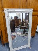 A RECTANGULAR MIRROR IN A GREY PAINTED FRAME, THE CORNERS WITH ROCOCO SHELL AND FLORAL SWAGS. 113