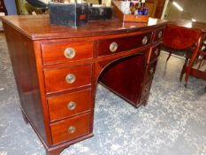 A VICTORIAN MAHOGANY BOW FRONT DESK, THE LONG DRAWER OVER A KNEEHOLE FLANKED BY BANKS OF FOUR