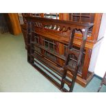 AN OAK DRESSER BACK, THE THREE OPEN BACKED CENTRAL SHELVES FLANKED BY FOUR NICHE TOPPED SHELVES