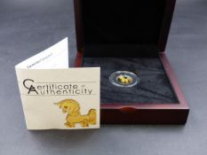 A BOXED PALAU COMMEMORATIVE COIN COMPANY GOLD UNICORN FROM AN EDITION OF 15000. 0.5 GRAMS.