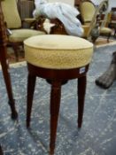 A SATINWOOD ADJUSTABLE PIANO STOOL, THE YELLOW UPHOLSTERED CIRCULAR SEAT ON FOUR LEAF TOPPED
