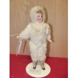 A BISQUE HEADED DOLL DRESSED IN CREAM FUR. H 31cms.