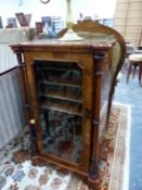 A VICTORIAN WALNUT MUSIC CABINET, THE THREE QUARTER GILT BRASS GALLERY ABOVE A GLAZED DOOR OVER FOUR