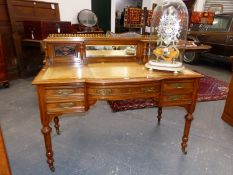 A LATE VICTORIAN WALNUT WRITING TABLE, A BRASS TOP RAIL OVER THE CENTRALLY MIRRORED TWO SHELF BACK