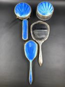 A FIVE PART SILVER HALLMARKED AND BLUE GUILLOCHE ENAMEL DRESSING TABLE SET.