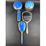 A FIVE PART SILVER HALLMARKED AND BLUE GUILLOCHE ENAMEL DRESSING TABLE SET.