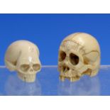 TWO IVORY CARVINGS OF SKULLS, ONE WITH BOTH SETS OF TEETH. H 3cms. THE OTHER WITHOUT SO MANY. H 3.